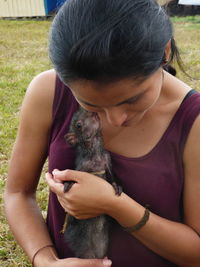 Smiling woman holding mammal