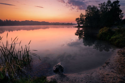 Scenic view of lake against sky during sunset