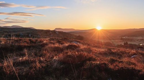 Scenic view of landscape against sky during sunset