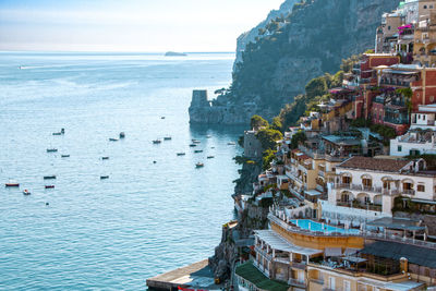 High angle view of buildings by sea