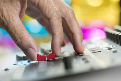 Close-up of hand using sound mixer