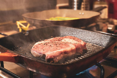 Close-up of meat in cooking pan