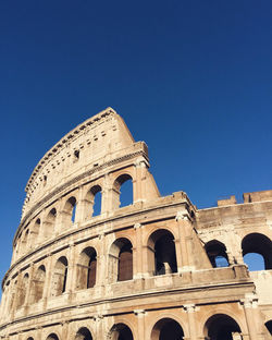 Low angle view of historical building against blue sky