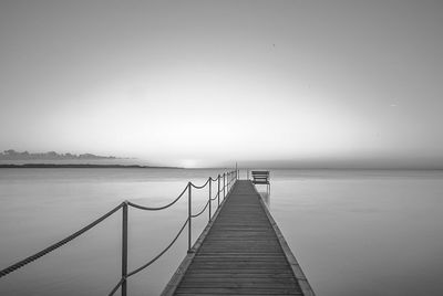 Pier over sea against clear sky