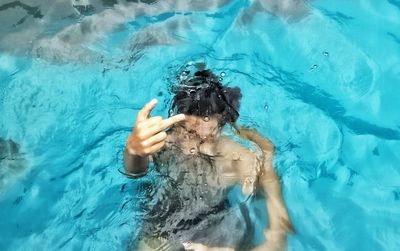 High angle view of woman swimming in pool