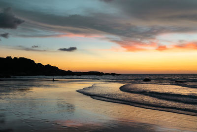 Scenic view of beach against sky during sunset