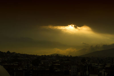 High angle view of residential district against cloudy sky during sunset