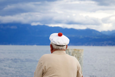 Rear view of fisherman looking at sea