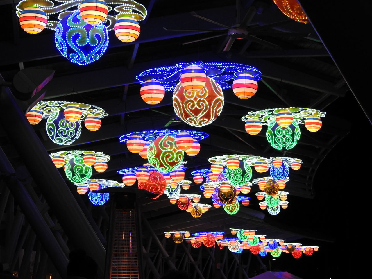 LOW ANGLE VIEW OF ILLUMINATED LANTERNS HANGING ON WALL