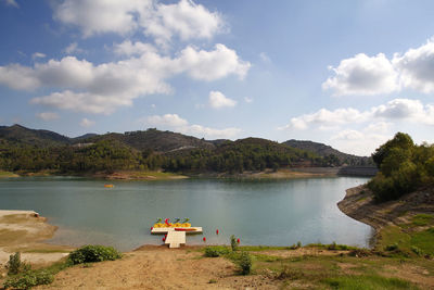 Scenic view of lake and mountains against sky