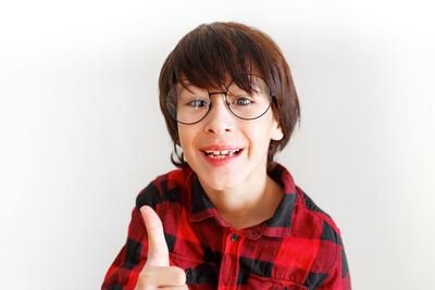 Portrait of smiling boy against white background