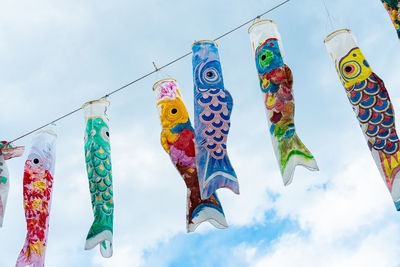 Low angle view of fish hanging against sky