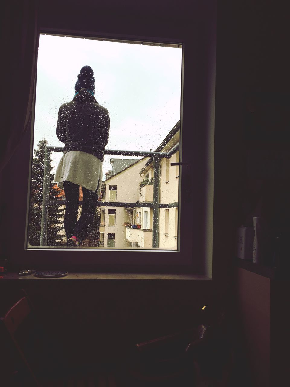 MAN LOOKING THROUGH WINDOW