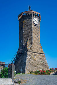 The ancient clock tower, symbol of the ancient village of marta, on the shore of the bolsena lake