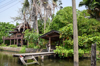 Gazebo by lake against trees