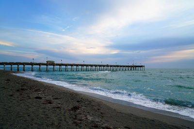 Pier over sea against sky