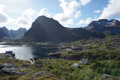 Scenic view of mountains and lake against cloudy sky