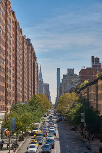 Road amidst cityscape against sky