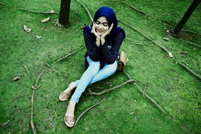 Portrait of young woman sitting outdoors