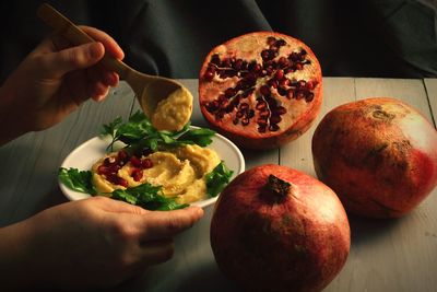 Close-up of hand holding food on table