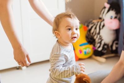 Cute baby girl at home with parents