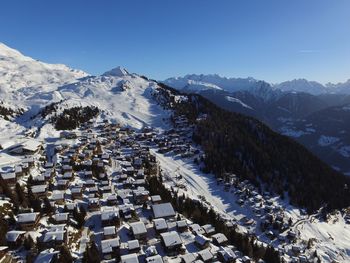 High angle view of snowcapped mountains against clear sky