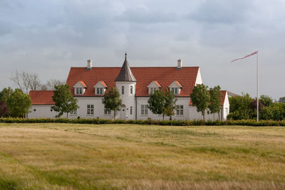 House on field against sky