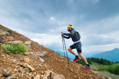 Man on rock against sky