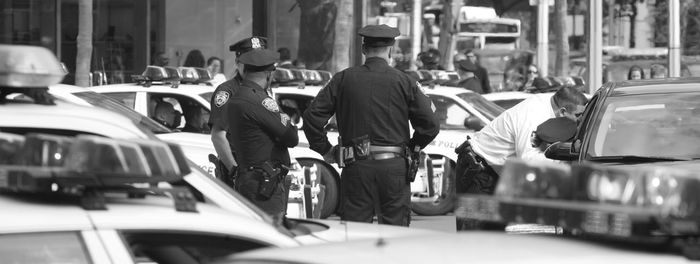 Police officers standing by cars