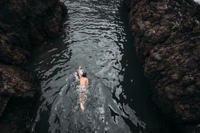 High angle view of man swimming in sea