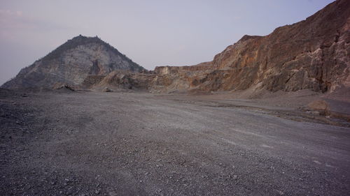 Scenic view of arid landscape against sky