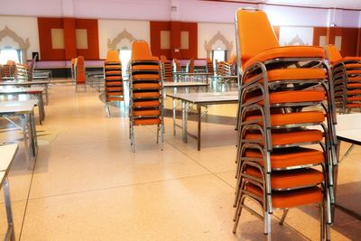 Empty chairs and tables in restaurant