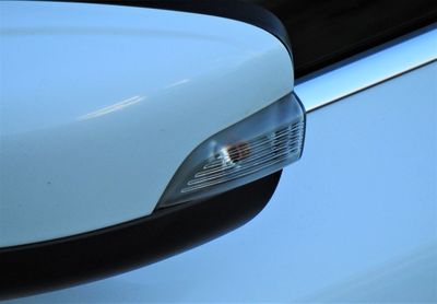 High angle view of car mirror against blue sky