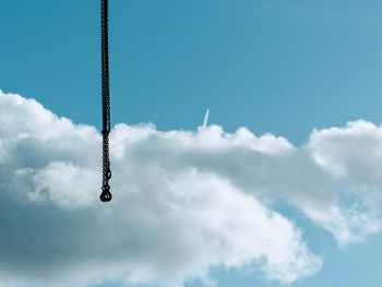 Low angle view of airplane flying against blue sky