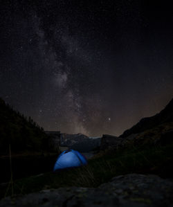 Scenic view of tent against milky-way at night