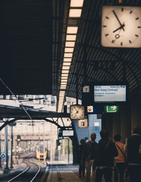 People waiting at railroad station