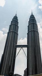 Low angle view of buildings against cloudy sky