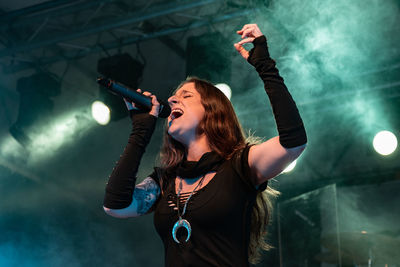 Young woman with arms raised