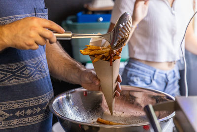 Midsection of man preparing food