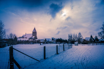 View of church against cloudy sky during winter