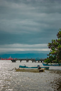 View of boats in sea against sky