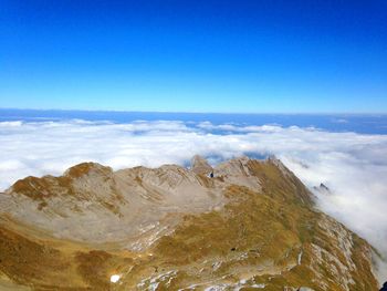 Scenic view of rocky mountains against blue sky