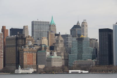 Buildings in city against clear sky