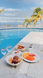 Food on table by swimming pool