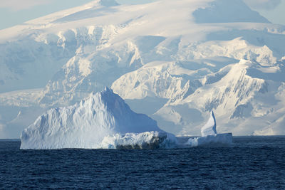 Scenic view of frozen sea against mountain