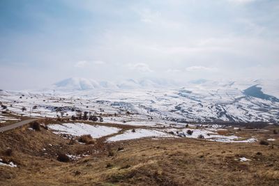 Scenic view of snowcapped mountains against sky