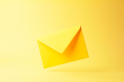 Close-up of yellow paper over white background