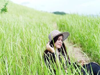 Portrait of woman wearing hat on field