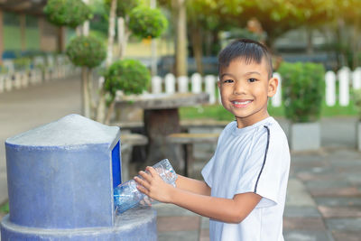 Portrait of smiling boy holding camera