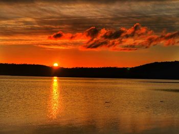 Scenic view of lake against romantic sky at sunset